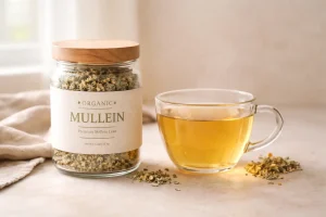 Organic mullein tea in cup with labeled jar on neutral background