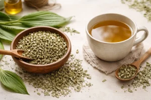 dried plantain leaves beside a cup of herbal tea on a clean botanical background